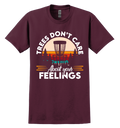 Maroon t-shirt with a disc golf graphic and text 'Trees Don't Care About Your Feelings' on a white background